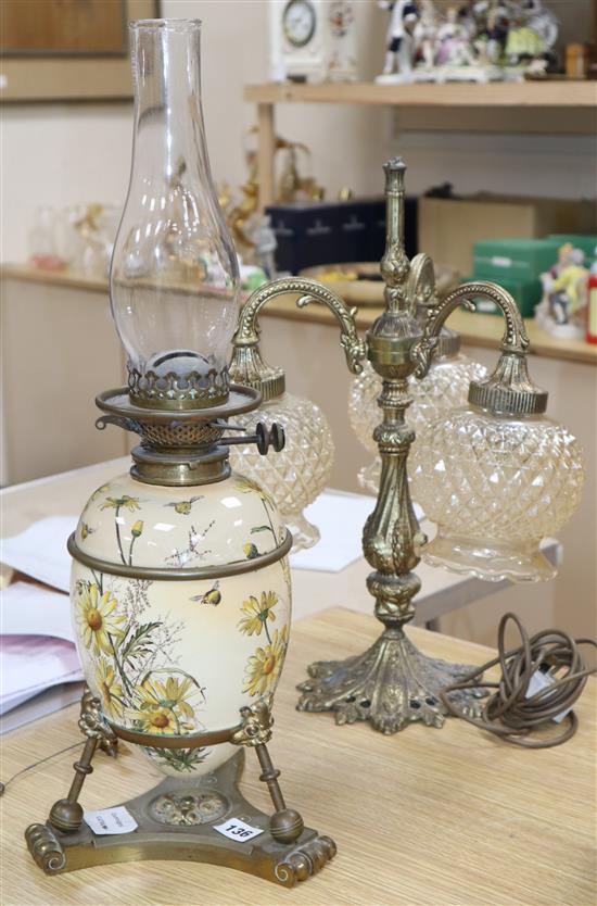 A Victorian brass and ceramic oil lamp and a cast gilt metal three light table lamp